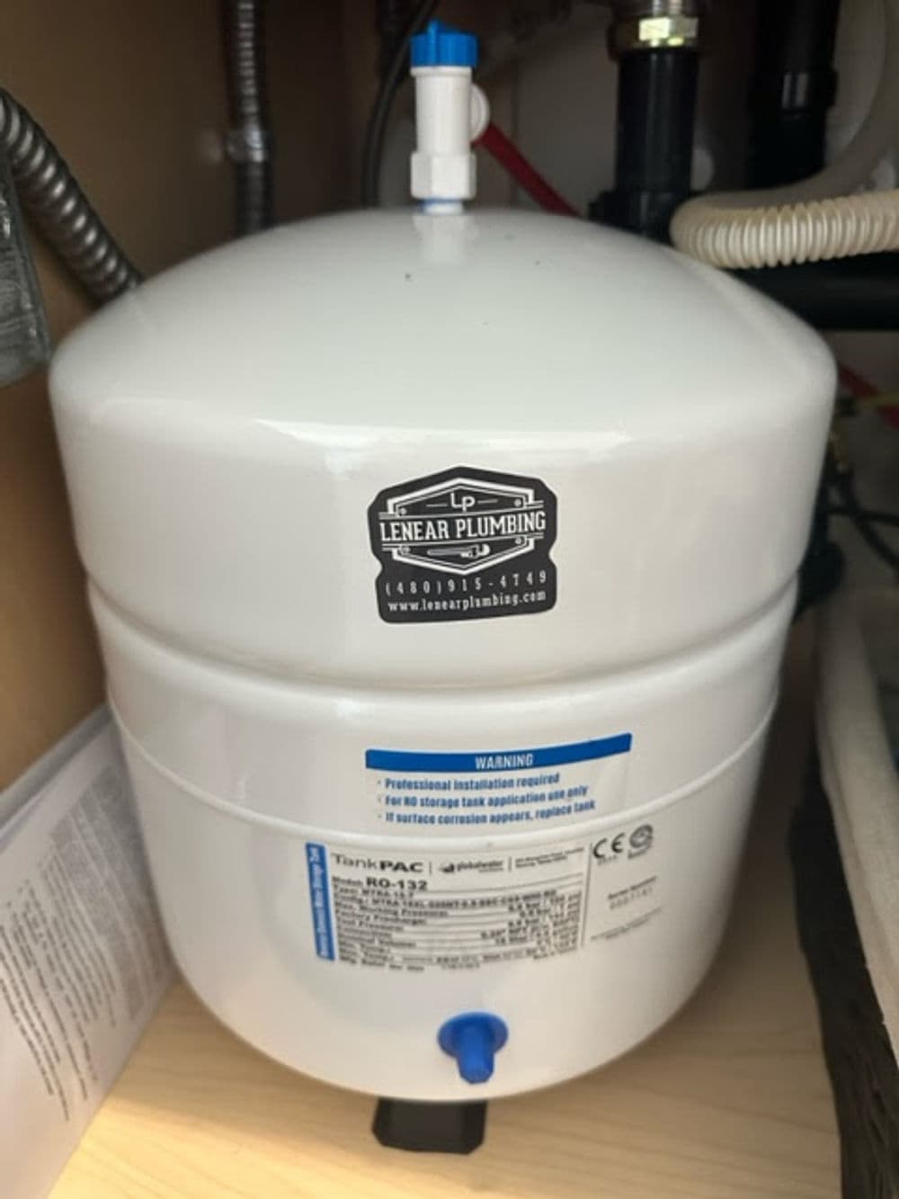 White water filtration tank under a sink with Lenear Plumbing logo, model RO-132.