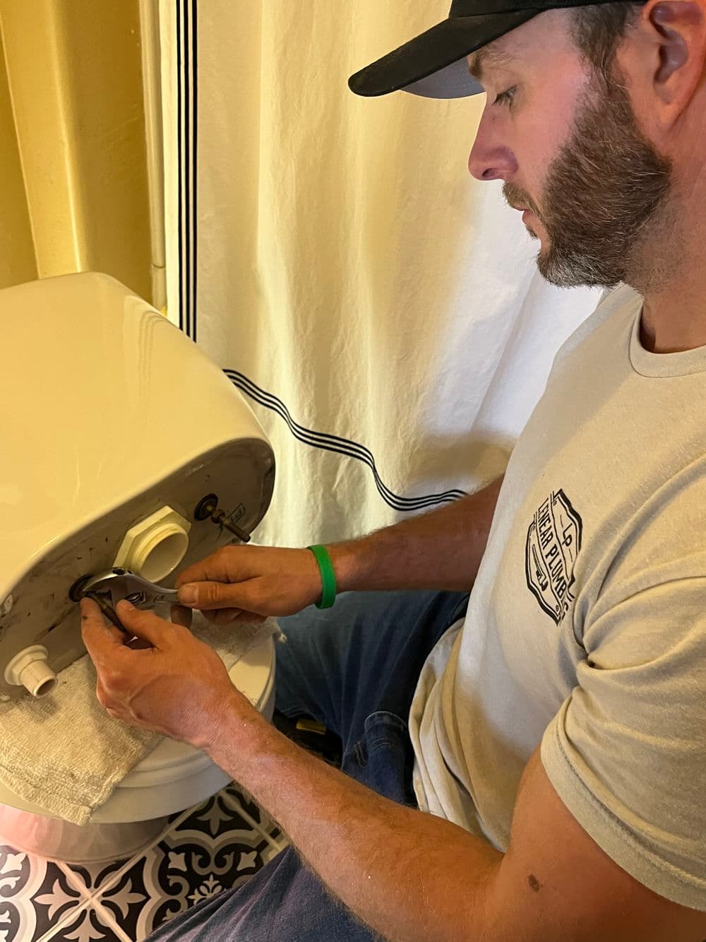 Man repairing a white appliance in a home setting, focusing on maintenance and DIY skills.